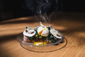 Dark green leafy spinach with poached eggs, breakfast idea by May Simpkin