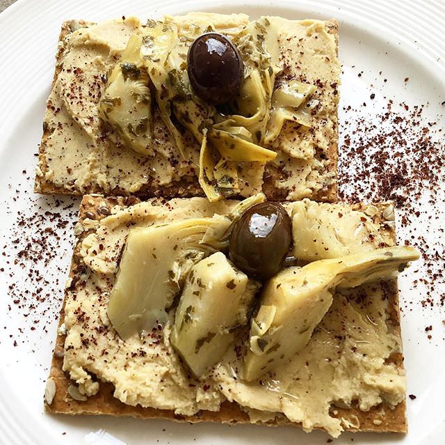 Hummus on toast with marinated artichokes for an easy healthy lunch